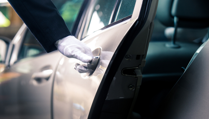 Closeup of Chauffeur with white glove opening car door
