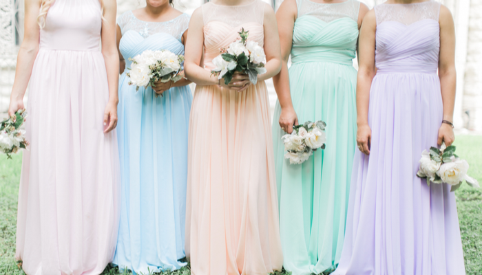 pastel bridesmaids dresses holding bouquets, pink, peach, blue, mint and purple gowns