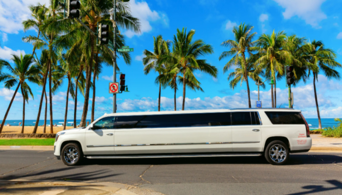 White stretch limo at a beach in a warm sunny day