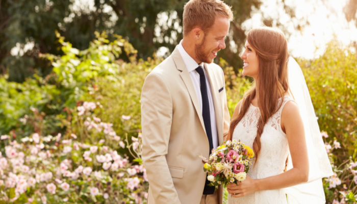 Romantic Young Couple Getting Married Outdoors in a hot summer day